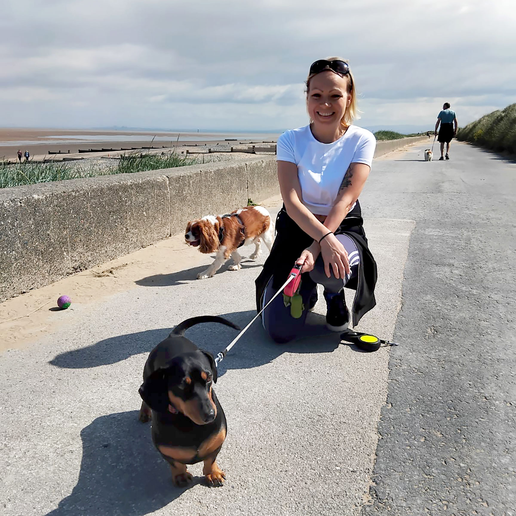 Lisa Ravenscroft with dogs on a beach, providing one-on-one dog boarding services at Woofington House in Manchester/Salford.